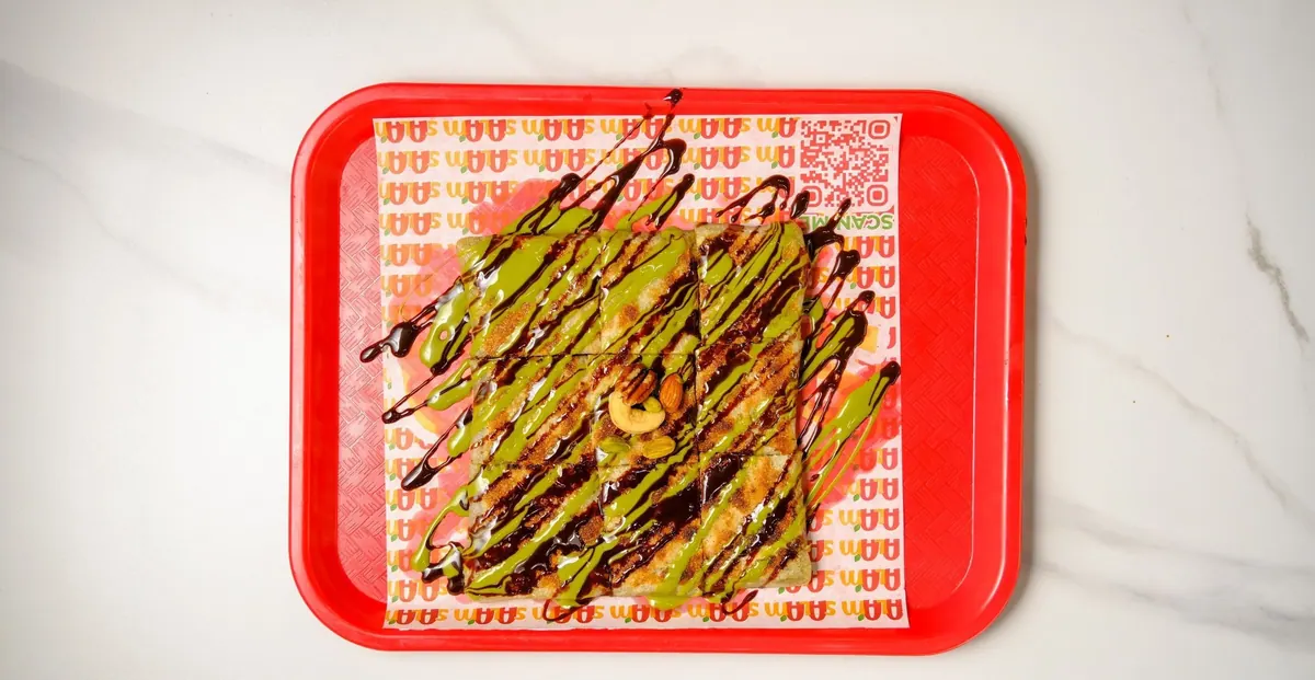 Dubai chocolate mutabbaq drizzled with chocolate and pistachio cream
